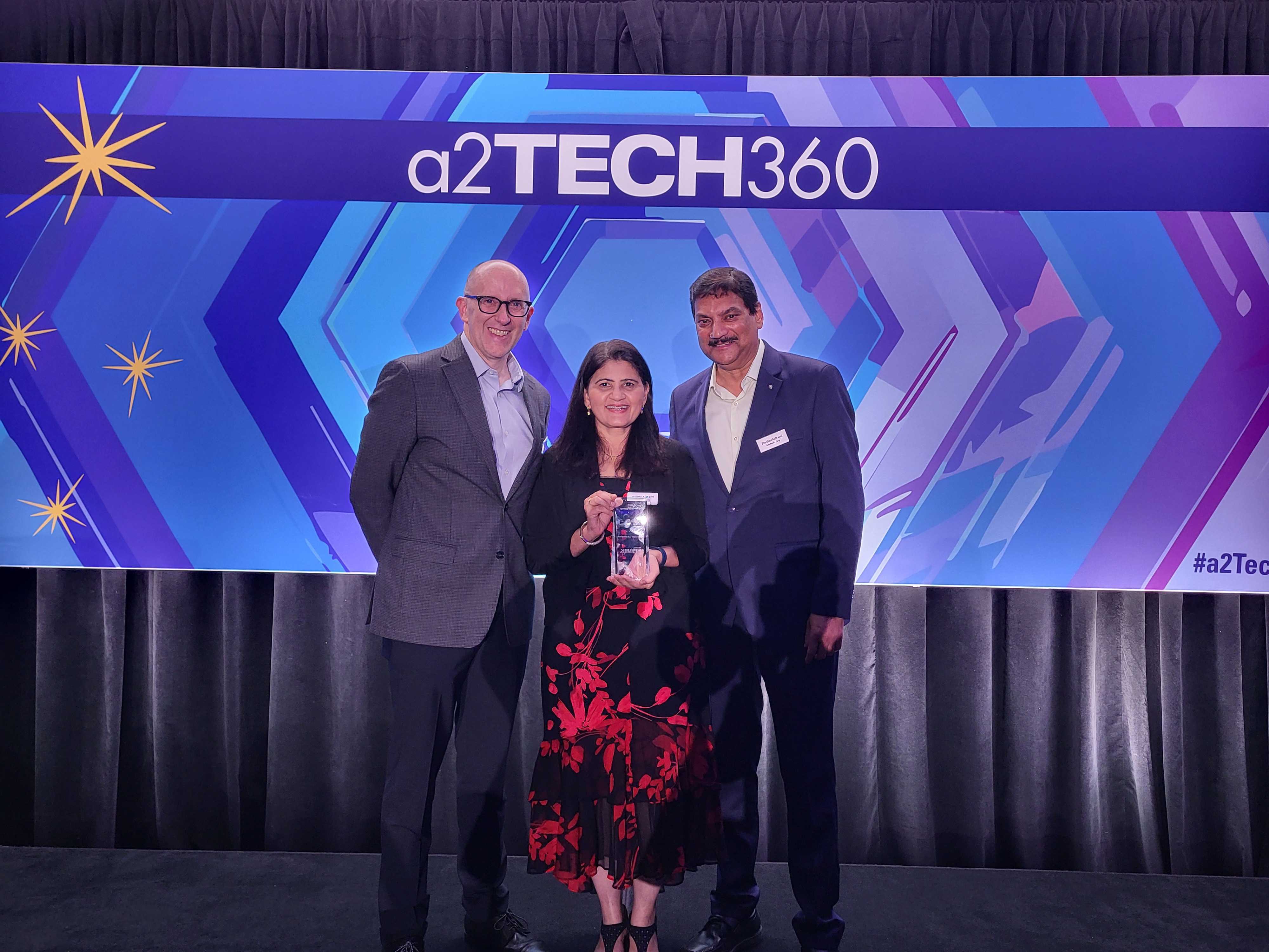 Eric Jacobson, Swatee & Bhushan Kulkarni accepting award