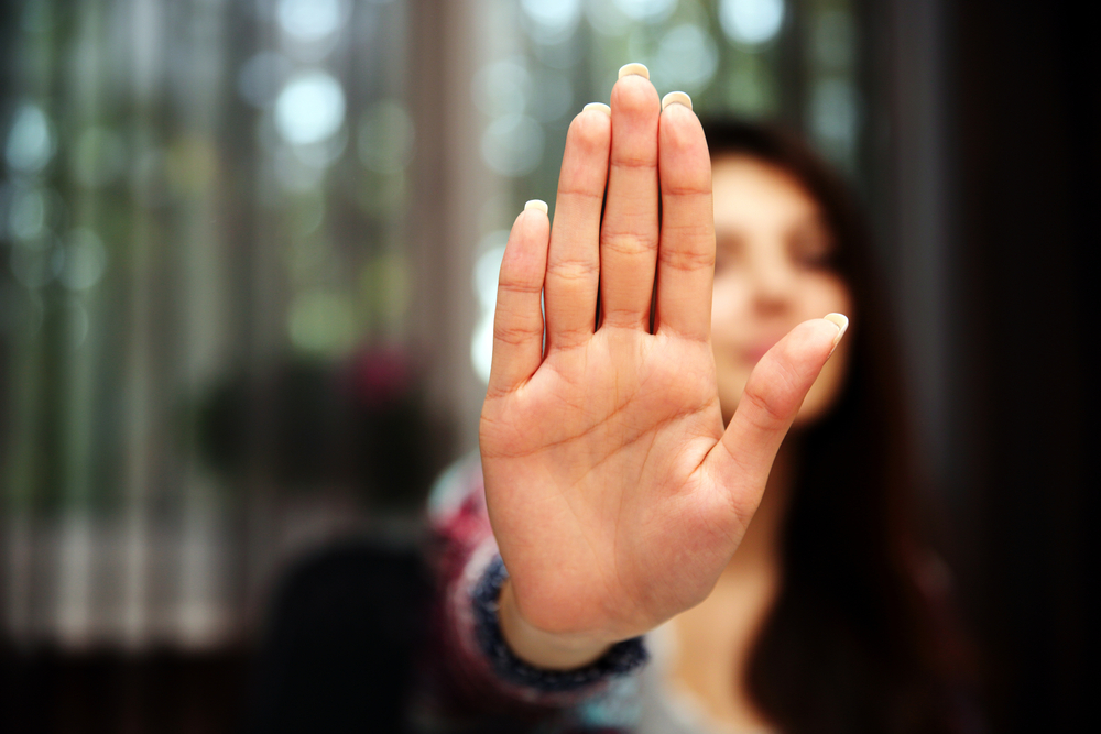 Woman with hand showing stop